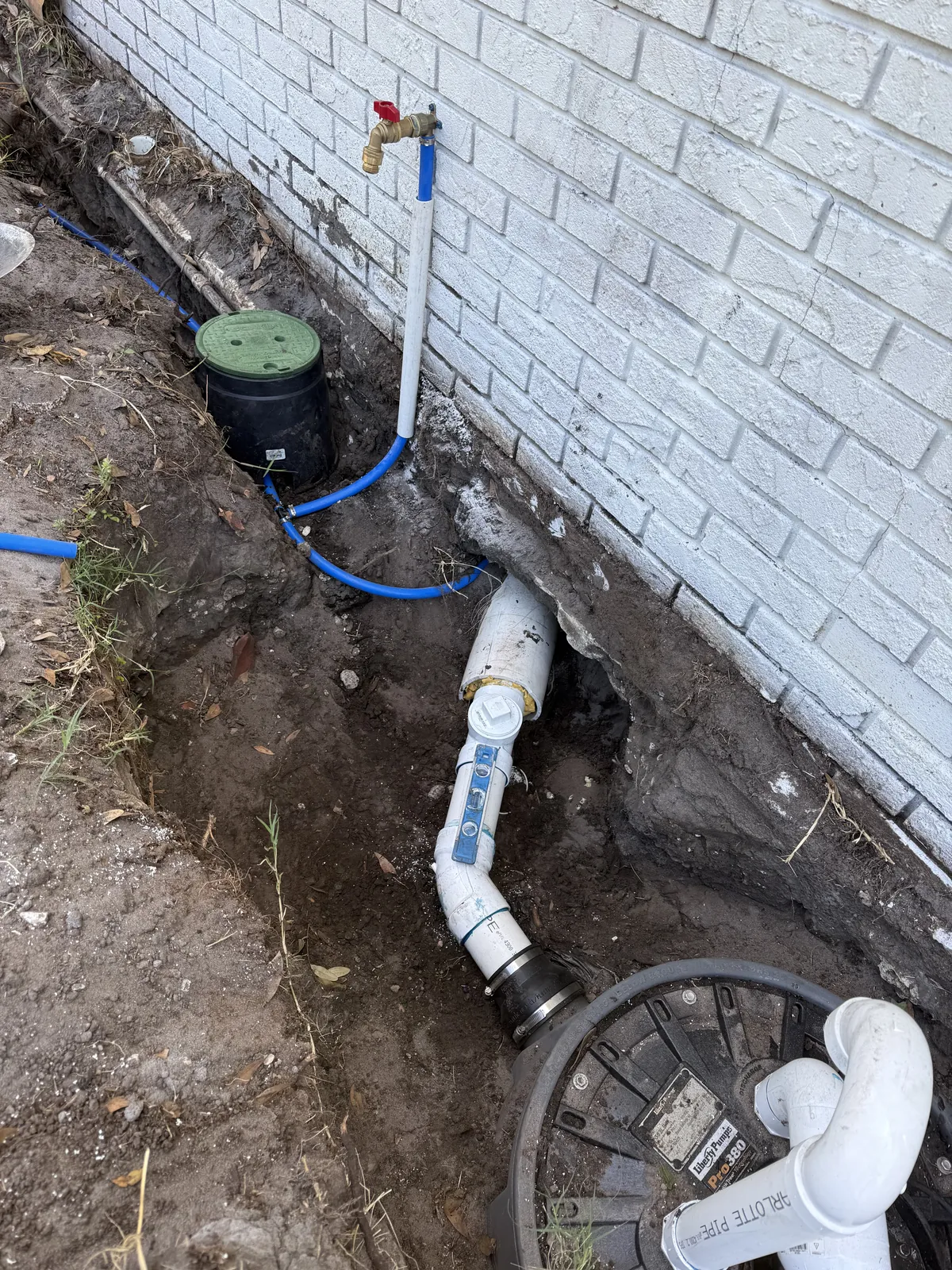OC's Plumbing & Septic full home repipe showing new PEX water lines routed at the foundation of a Central Florida home