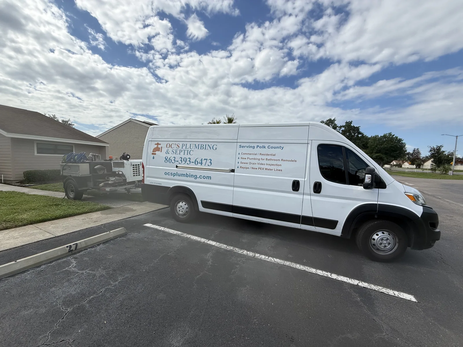 OC's Plumbing & Septic service van and equipment at a Central Florida residential job site