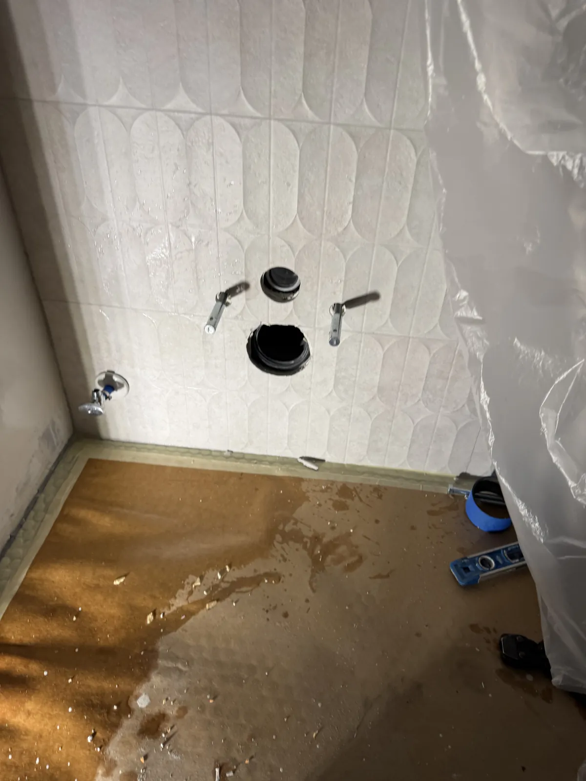 OC's Plumbing & Septic shower valve installation in progress showing exposed valve body and plumbing rough-in